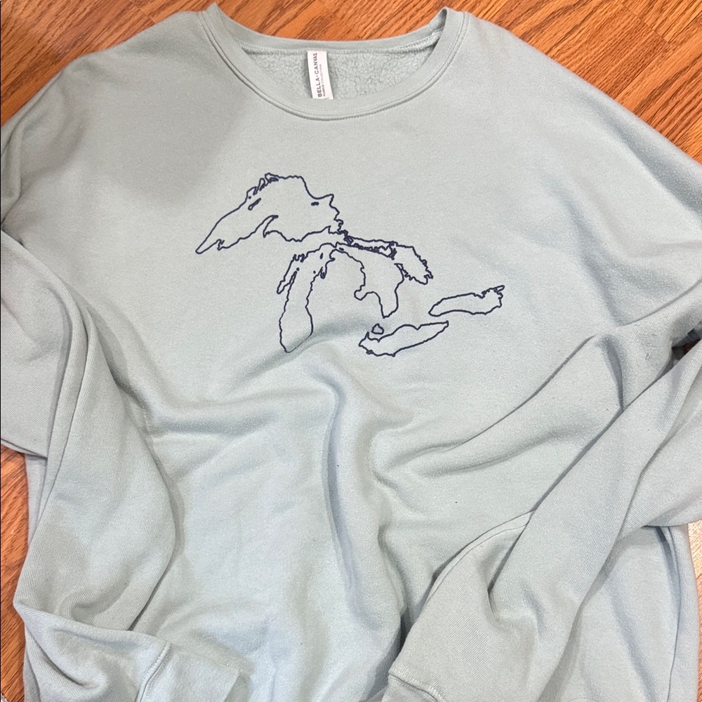 Light Blue Crew Neck Sweater with Graphic Design